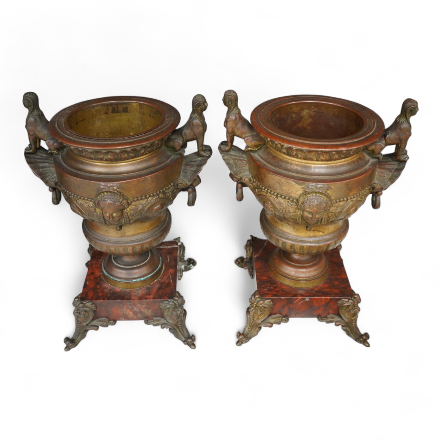 A pair of late 19 century French Egyptian revival bronze and rouge marble urns, 31cm high